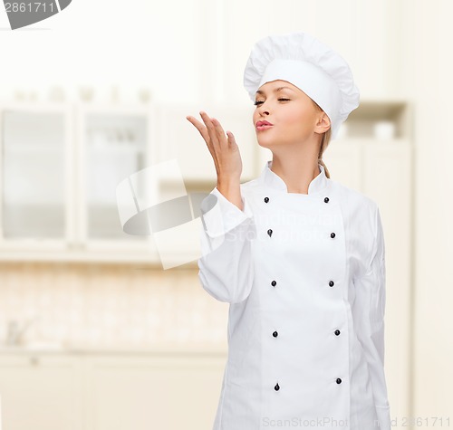 Image of smiling female chef showing delicious sign