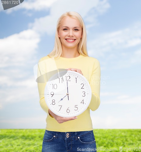 Image of student with wall clock