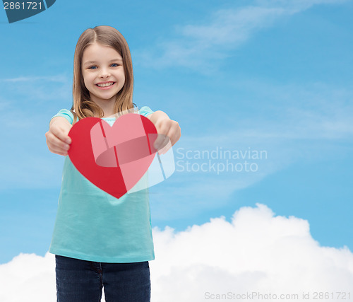 Image of smiling little girl giving red heart