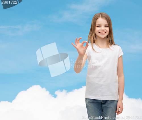 Image of little girl in white t-shirt showing ok gesture