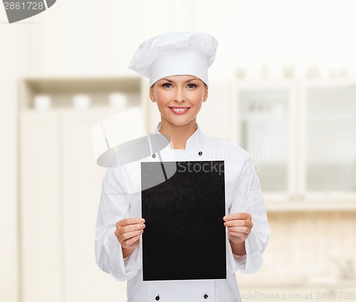 Image of smiling female chef with black blank paper