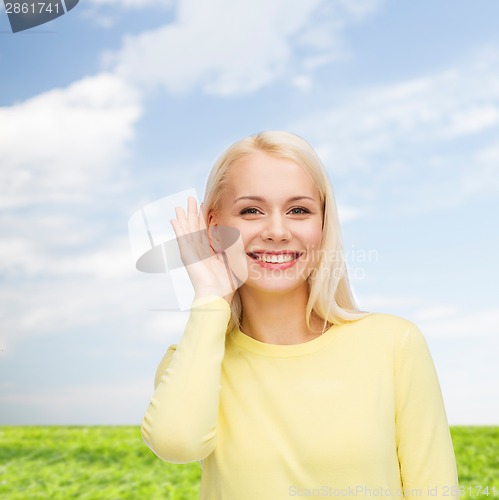 Image of smiling young woman listening to gossip