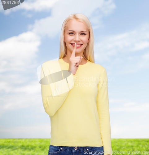 Image of young woman with finger on her lip