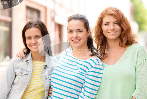 Image of smiling teenage girls with on street