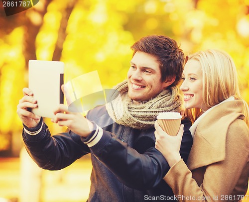 Image of couple taking photo picture autumn park