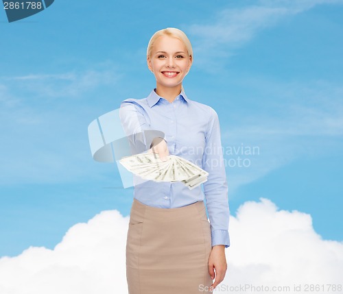 Image of young businesswoman with dollar cash money