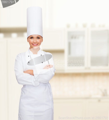 Image of smiling female chef with crossed arms