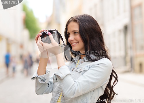 Image of smiling teenage girl with camera