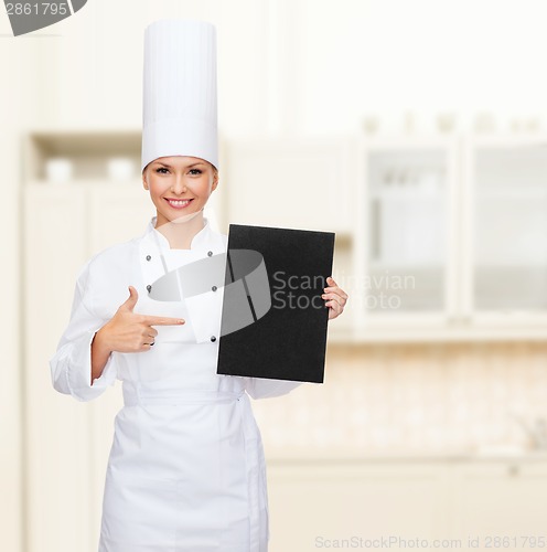 Image of smiling female chef with black blank paper