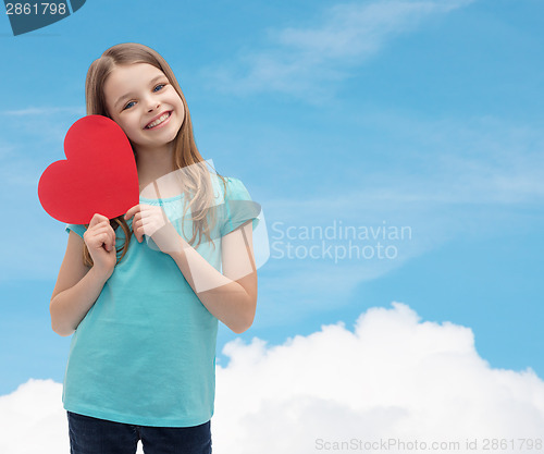 Image of smiling little girl with red heart