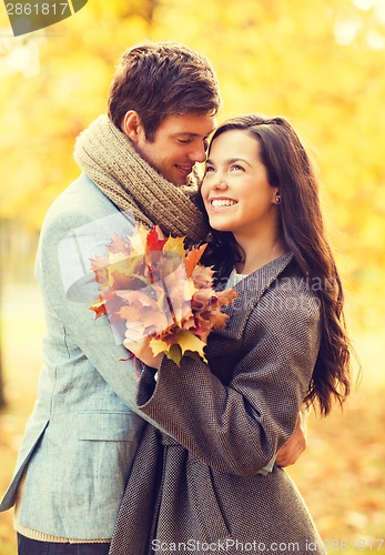 Image of romantic couple kissing in the autumn park