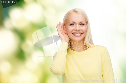 Image of smiling young woman listening to gossip