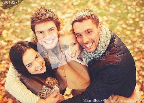 Image of group of friends having fun in autumn park