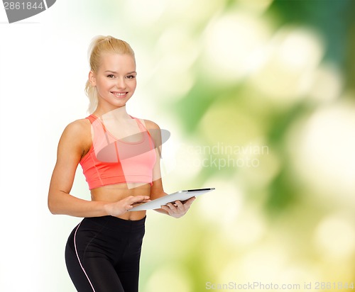 Image of smiling sporty woman with tablet pc computer