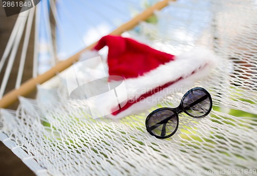 Image of hammock with santa helper hat and shades