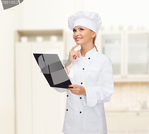 Image of smiling female chef with black blank paper