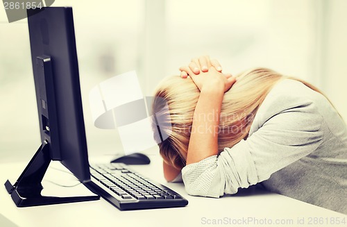 Image of stressed woman with computer