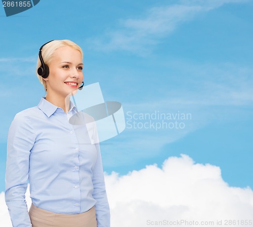 Image of friendly female helpline operator with headphones