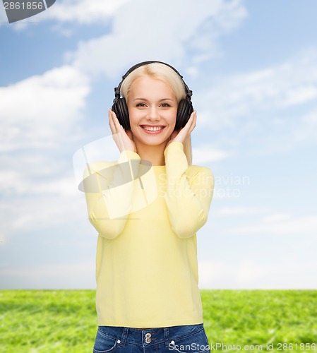 Image of smiling young woman with headphones