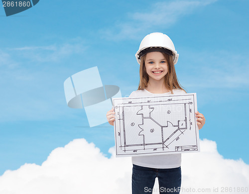 Image of smiling little girl in helmet showing blueprint