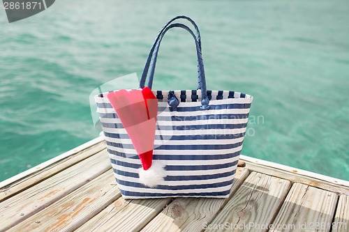 Image of close up of beach bag and santa helper hat