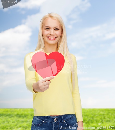 Image of smiling woman with red heart