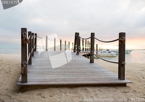 Image of close up of pier on tropical beach