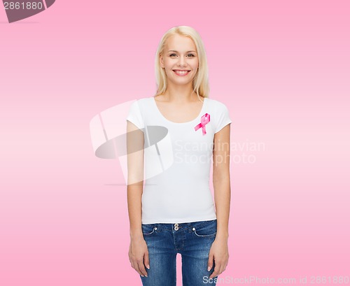 Image of smiling woman with pink cancer awareness ribbon