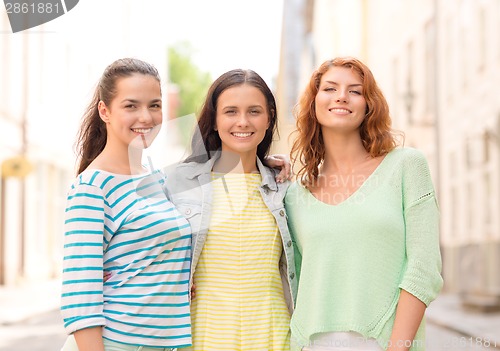 Image of smiling teenage girls with on street