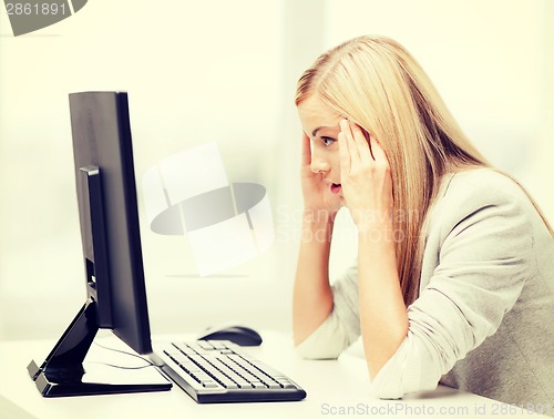 Image of stressed woman with computer