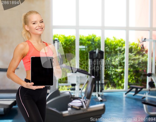 Image of smiling woman showing tablet pc blank screen