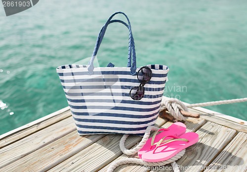 Image of close up of beach accessories on wooden pier