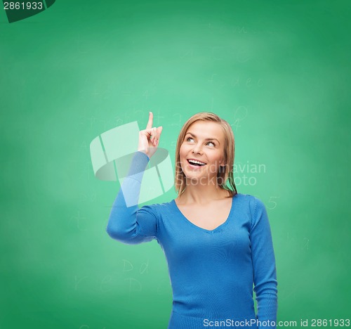 Image of smiling woman pointing her finger up