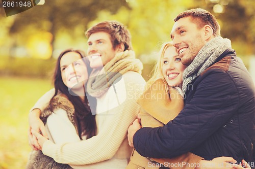 Image of group of friends having fun in autumn park