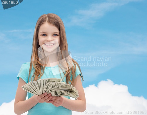 Image of smiling little girl with dollar cash money