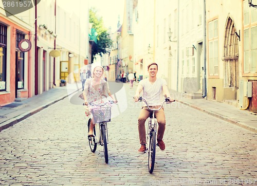 Image of couple with bicycles in the city