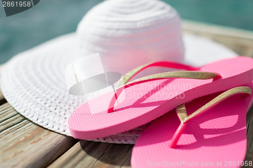 Image of close up of hat and slippers at seaside