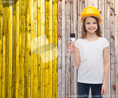 Image of smiling little girl in helmet with paint roller