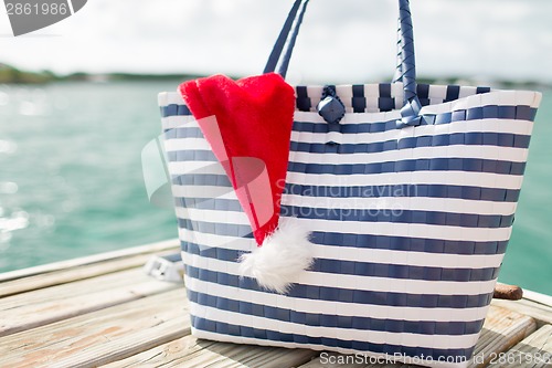 Image of close up of beach bag and santa helper hat