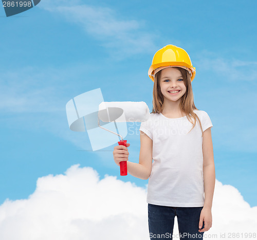 Image of smiling little girl in helmet with paint roller