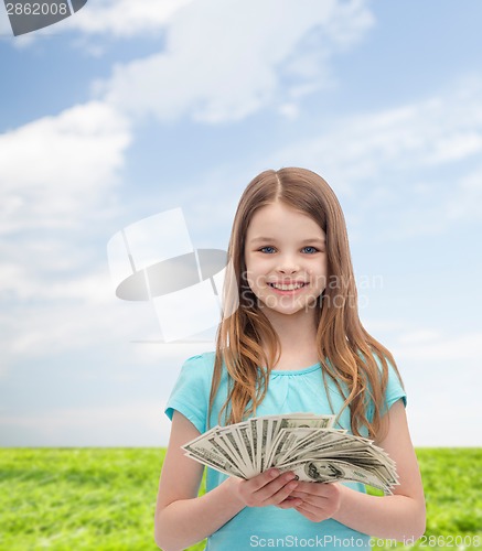 Image of smiling little girl with dollar cash money