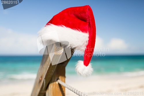 Image of close up of santa helper hat on beach