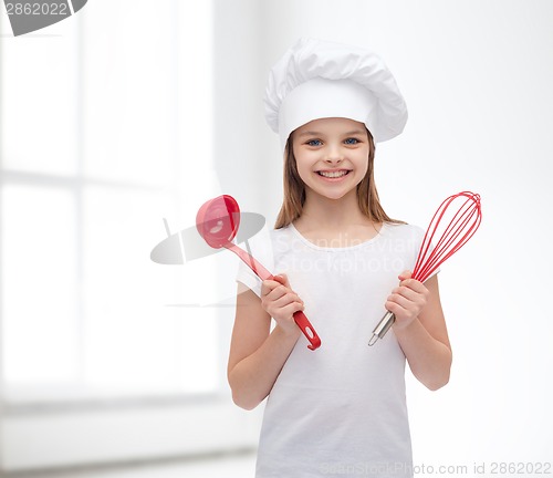 Image of smiling girl in cook hat with ladle and whisk