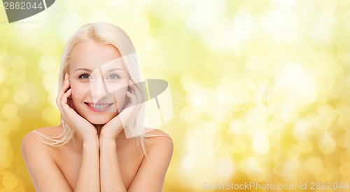 Image of beautiful woman touching her face skin