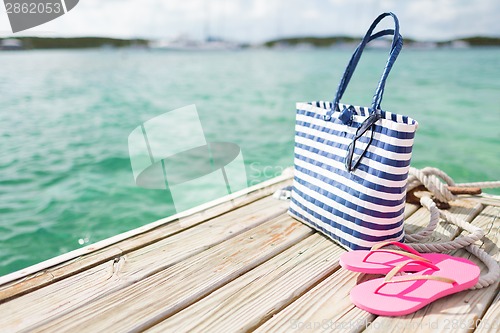 Image of close up of beach accessories on wooden pier