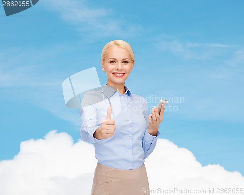 Image of young smiling businesswoman with smartphone