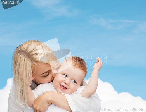 Image of happy mother kissing smiling baby