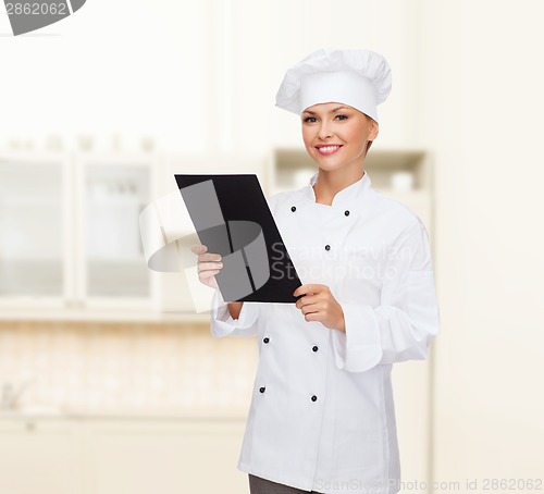 Image of smiling female chef with black blank paper