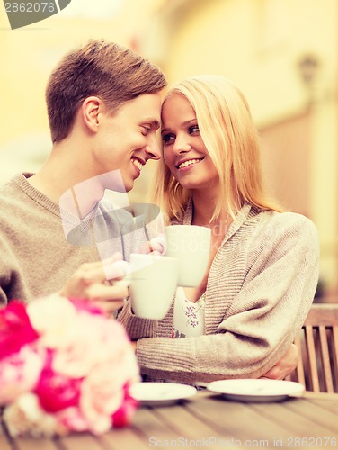 Image of romantic happy couple kissing in the cafe