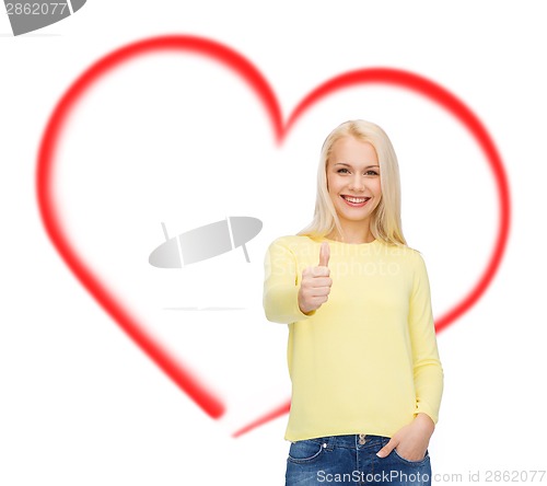 Image of smiling girl in casual clothes showing thumbs up